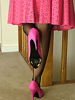 This honey looks stunning in a pink dress black seamed nylons and high heels